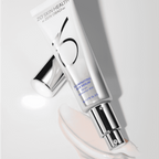 Illuminating skin serum in sleek silver tube, promoting healthy, radiant skin.