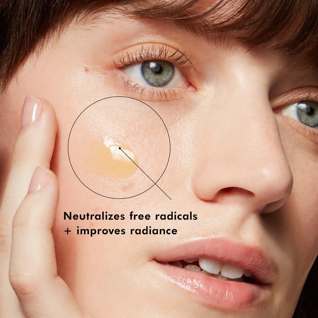 Woman applying skincare cream to face, promoting radiant skin and radical neutralization.