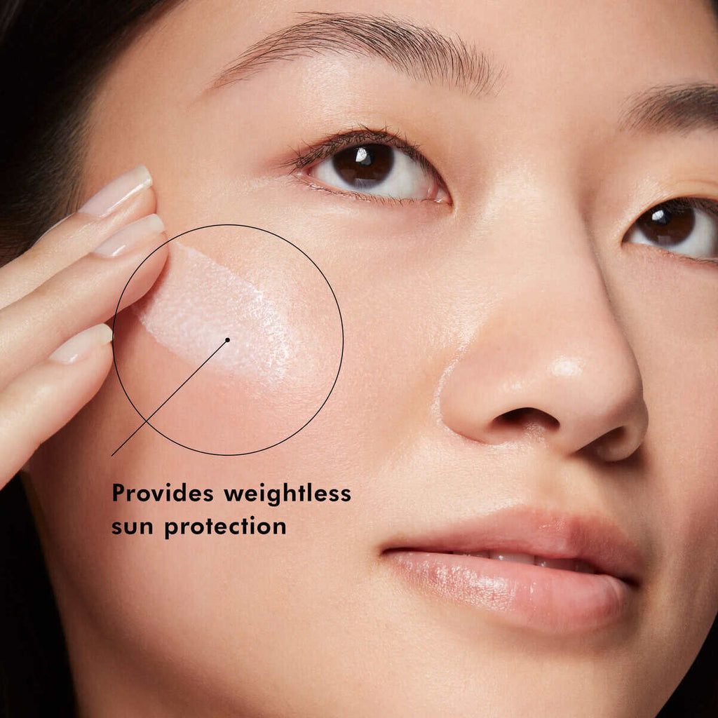 Woman applying skincare with sun protection for healthy, radiant skin.
