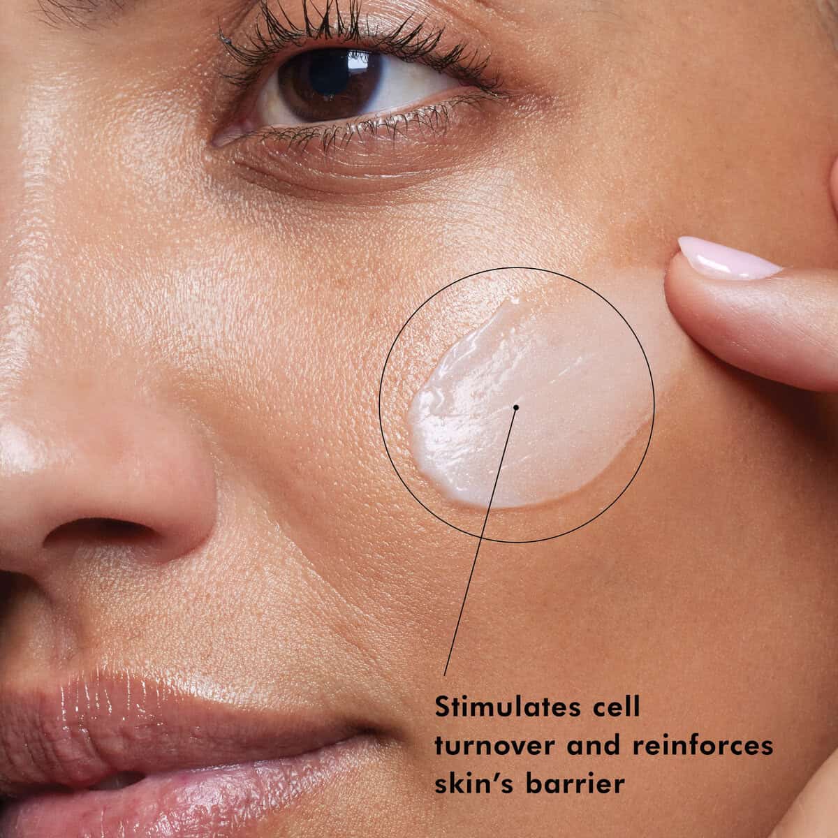 Close-up of a woman's cheek with skincare product, highlighting skin renewal benefits.