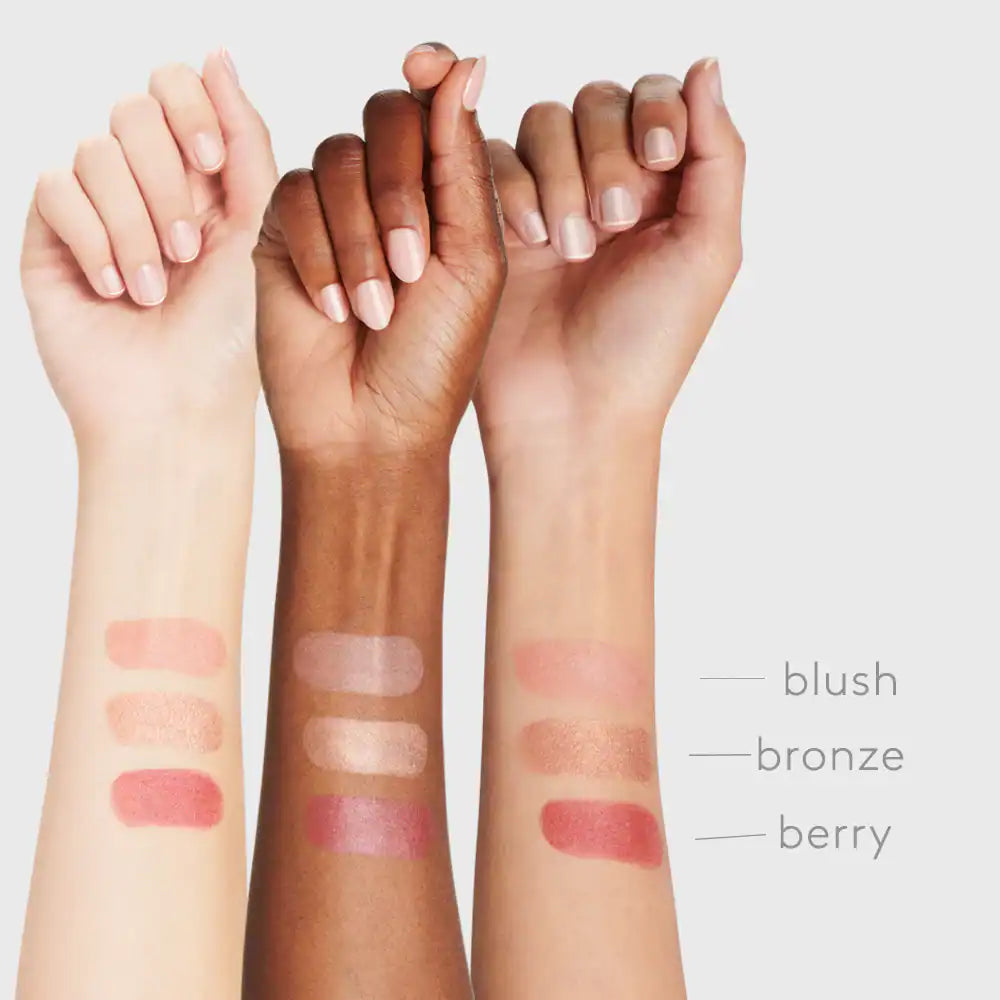Diverse skin tones with blush swatches on arms, showcasing natural beauty and makeup variety.
